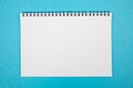 Photo of a blank white notepad on an isolated blue background Royalty Free Stock Photo