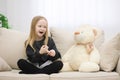 Photo of blond girl talking to her toy plush friend. Royalty Free Stock Photo