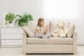 Photo of blond girl talking to her toy plush friend. Royalty Free Stock Photo