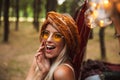 Photo of blond hippy woman, wearing stylish accessories smiling Royalty Free Stock Photo