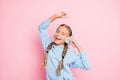 Photo of blonde haired cheerful positive cute nice singing girl dancing with her favorite song in headphones isolated Royalty Free Stock Photo