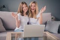 Photo of blonde small girl and mature woman sit couch wave hello web camera laptop sit couch indoors inside house Royalty Free Stock Photo