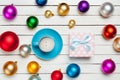 Photo of blue cup of coffee and cute gift near colorful baubles Royalty Free Stock Photo