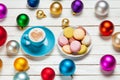 Photo of blue cup of coffee and plate full of macaroons near col Royalty Free Stock Photo