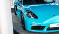 A modern blue Porsche sports car