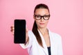 Photo of blurred pretty charming woman dressed white blazer glasses showing modern gadget isolated pink color background