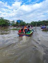 Photo of a boat carrying tourists down the Martapura river in Banjarmasin, Indonesia Royalty Free Stock Photo