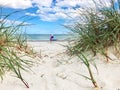 Photo of boat with colorful sails on white sand beach at cloudy weather in north Germany Royalty Free Stock Photo