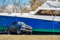 Photo of a boat pinning down a pick up truck after Hurricane Ian storm surge aftermath