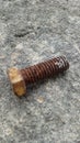 Photo of a bolt on a rusty floor