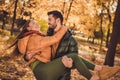 Photo of bonding soulmate couple guy hold his girlfriend with hands in fall september park wear season coats Royalty Free Stock Photo