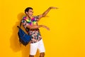 Photo of boogie woogie party guy t shirt has chill vibe dance in hawaiian necklace and backpack isolated over yellow