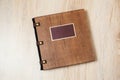 Photo book in a brown wooden cover