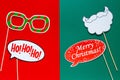 Photo booth colorful props for christmas party - beard, glasses on sticks on green red background. Christmas and New year Royalty Free Stock Photo