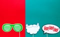 Photo booth colorful props for christmas party - beard, glasses on sticks on green red background. Christmas and New year Royalty Free Stock Photo