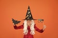 Photo booth props. Small girl in black witch hat. Autumn holiday. Join celebration. Little child in witch costume