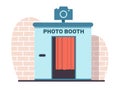 Photo booth for quick photos near brick wall. Digital kiosk for passport, family and wedding photos. Kiosk with red