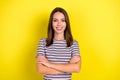 Photo of boss young brunette lady crossed arms wear striped t-shirt isolated on yellow background