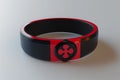 A photo of a bracelet featuring a cross charm, designed with a combination of black and red colors, A 3D render of a food allergy Royalty Free Stock Photo
