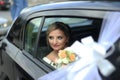 Portrait of happy bride looks out of the car window Royalty Free Stock Photo