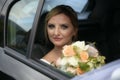 Portrait of happy bride looks out of the car window Royalty Free Stock Photo