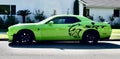 Photo of a bright Neon green SRT Dodge Sports Car parked on street Royalty Free Stock Photo