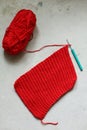 a bright red yarn with a crochet hook