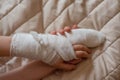 Photo of a broken arm of a child in a plaster case, an injury to the hand as a result of an accident, a fracture of the