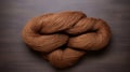 Handcrafted Beauty: Brown Skein On Wooden Background With Luminous Sfumato Style