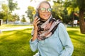 Photo of brunette islamic woman wearing headscarf speaking on mobile phone