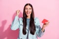 Photo of brunette victorious woman raise fist celebrate win video game isolated on pink color background