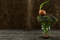 Photo of a buckwheat and fresh green broccoli in pot, green onion on the broccoli standing on the wooden table with Royalty Free Stock Photo