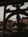Photo of a building shot through a silhouette of a metal railing
