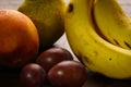 photo of a bunch of bananas peaches plums natural fruits