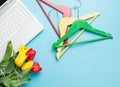 Photo of bunch of tulips, colorful hangers and laptop on the won Royalty Free Stock Photo