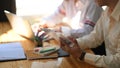 Photo of business development team working together with computer laptop, clipboard.