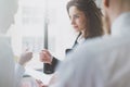 Photo business partners meeting. Team succes. Businesswoman giving businesS card colleague. Blurred background, film