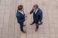 Photo of business partners talk conversation outdoor. Two handsome businessmen in suits discuss a working project Royalty Free Stock Photo
