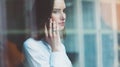 Photo business woman wearing modern suit, talking smartphone and holding papers in hands. Open space loft office Royalty Free Stock Photo