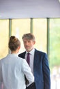 Businessman discussing with young businesswoman at new office Royalty Free Stock Photo