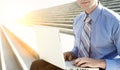 Businessman working on his laptop while sitting on stairs