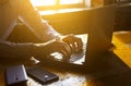 Photo businessman working on modern loft office. Man sitting wood table and using contemporary notebook, texting message keyboard. Royalty Free Stock Photo