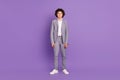 Photo of calm concentrated confident pupil schoolboy guy posing wear grey suit isolated violet color background