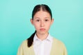 Photo of calm focused dilligent pupil lady serious look camera wear green top cardigan isolated teal color background Royalty Free Stock Photo