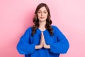 Photo of calm peaceful focused girl wear blue comfort clothes two arm together pray for peace isolated on pink color