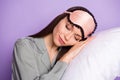 Photo of calm sleepy young nice woman lie pillow wear night mask isolated on purple color background