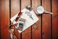 Photo camera, mug, sunglasses, notebook and wildflowers herbs on