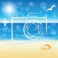 Photo camera silhouette on the sunny beach backgro