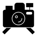 Photo camera on tripod solid icon. Photograph vector illustration isolated on white. Camera on stand glyph style design Royalty Free Stock Photo