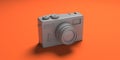 Vintage film photo camera monochrome silver gray color isolated on orange color background. 3d illustration